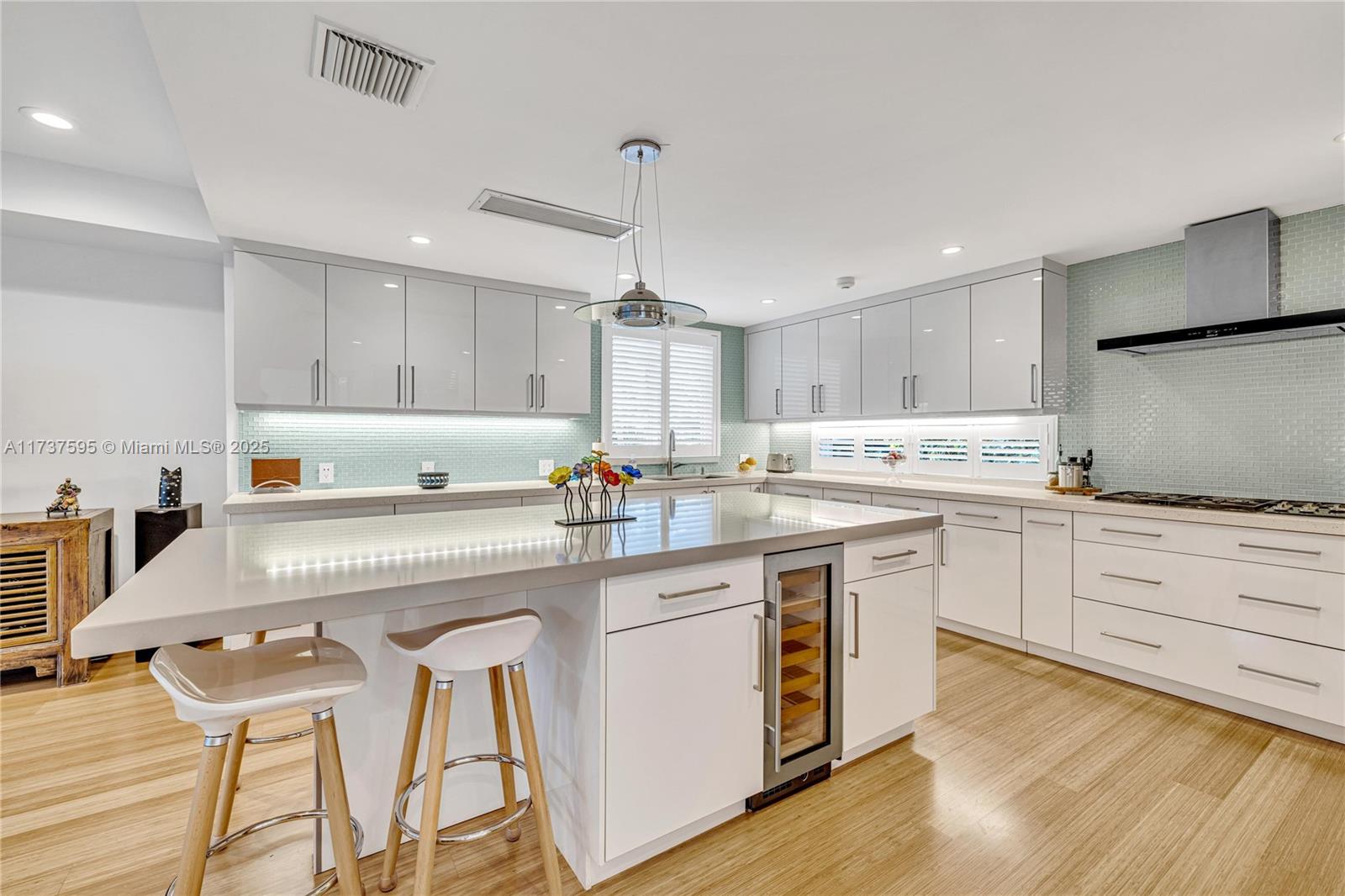3701 Solana Road Miami, FL 33133 - Photo 13 of 38 a kitchen with granite countertop white cabinets and white appliances