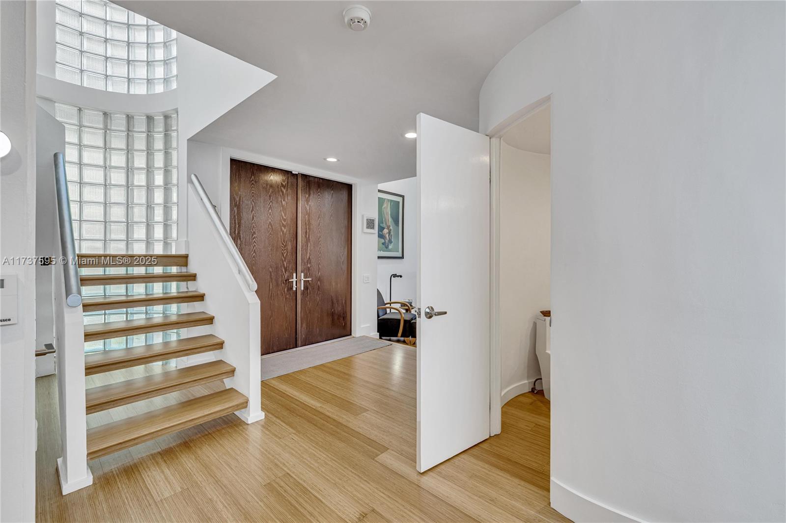 3701 Solana Road Miami, FL 33133 - Photo 17 of 38 a view of entryway with wooden floor and stairs