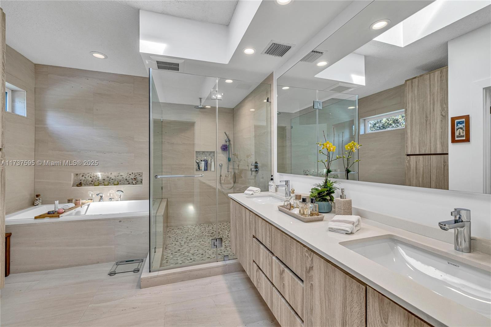 3701 Solana Road Miami, FL 33133 - Photo 24 of 38 a bathroom with a sink double vanity granite tub shower and a mirror
