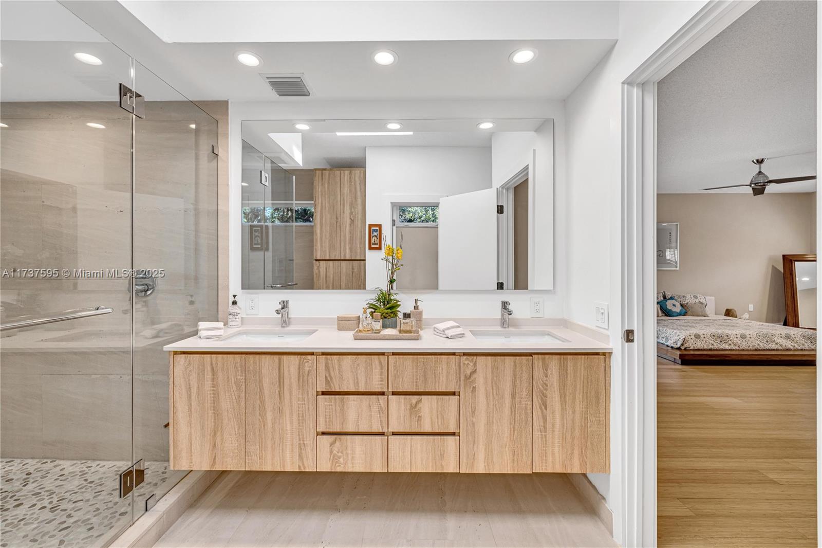 3701 Solana Road Miami, FL 33133 - Photo 25 of 38 a bathroom with a double vanity sink mirror and double