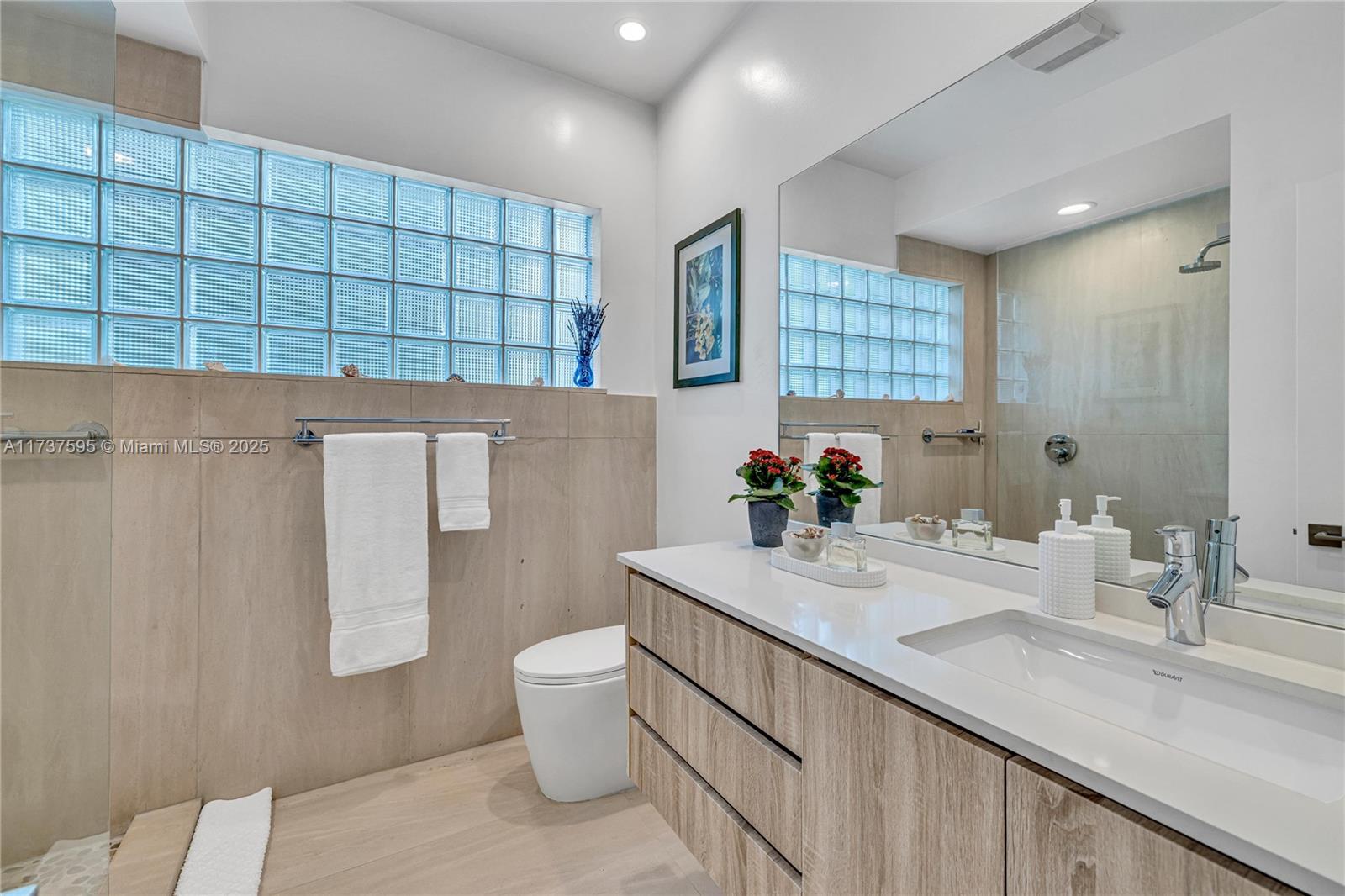 3701 Solana Road Miami, FL 33133 - Photo 28 of 38 a bathroom with a sink a toilet and shower