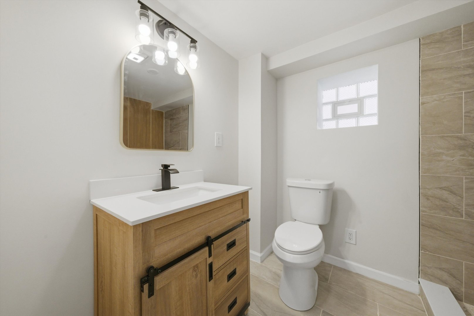 3907 West Marquette Road Chicago, IL 60629 - Photo 24 of 32 a bathroom with a toilet a sink and mirror