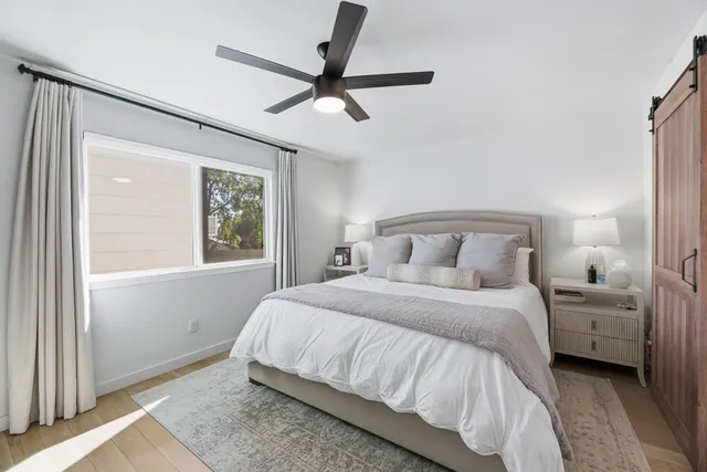 a bedroom with a large bed and a window