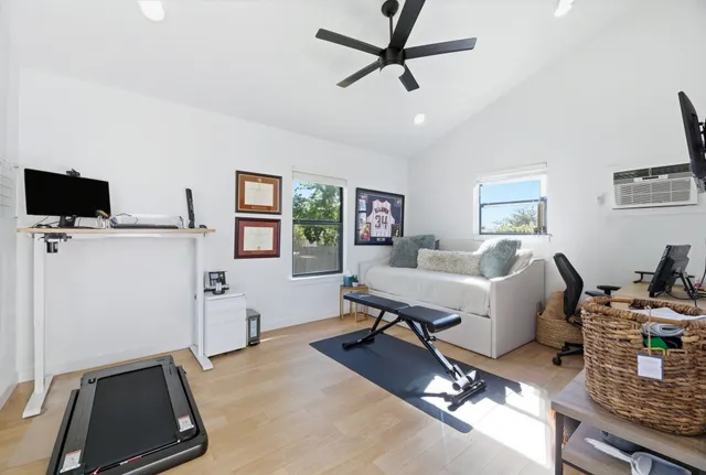 a living room with furniture a flat screen tv and a window