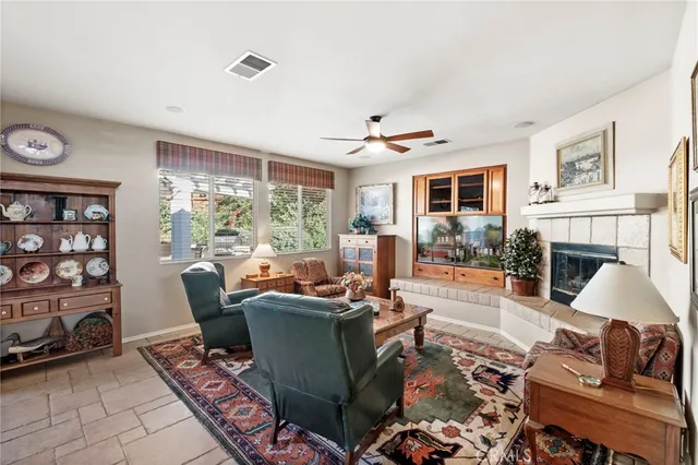 a living room with furniture and a floor to ceiling window