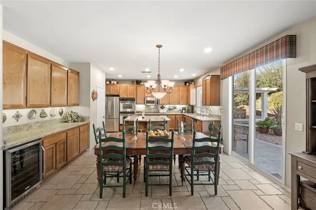a kitchen with kitchen island granite countertop a sink counter and stainless steel appliances