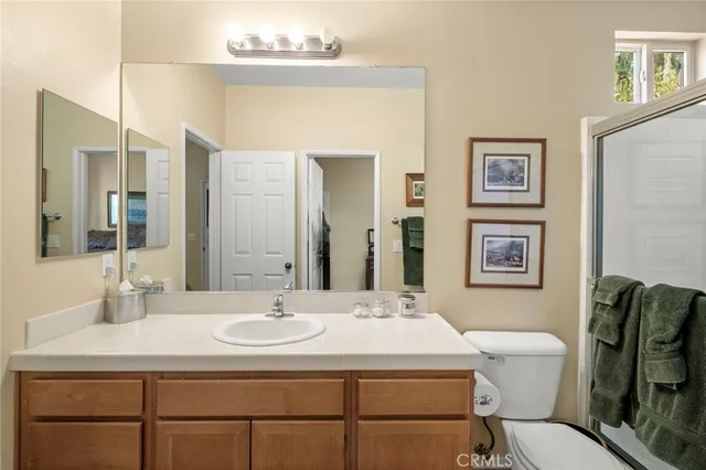 a bedroom with a bed and a dresser with wooden floor