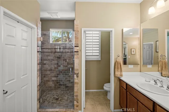 a bathroom with a sink double vanity granite and a large mirror
