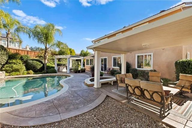 a outdoor living space with furniture potted plant and a large window