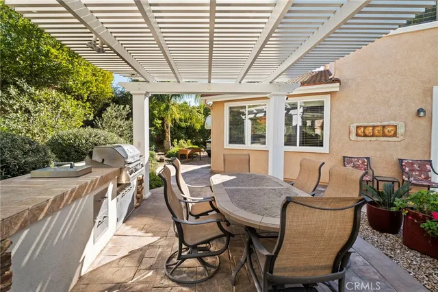a view of a patio with table and chairs with wooden floor and fence
