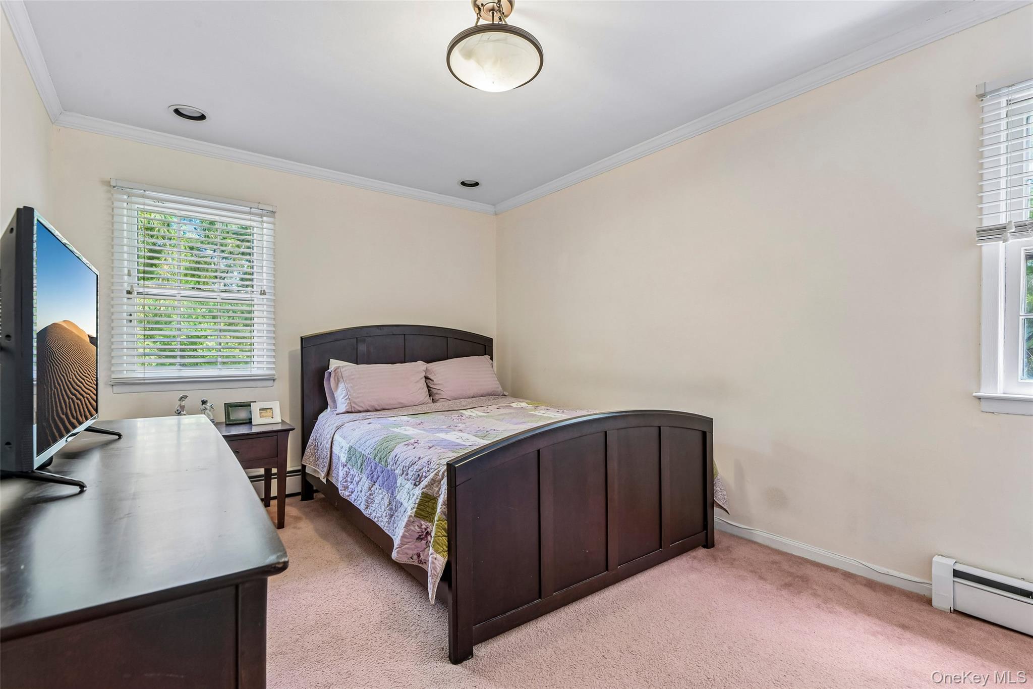100 Hewlett Neck Road Woodmere, NY 11598 - Photo 29 of 45 a bedroom with a bed and a desk