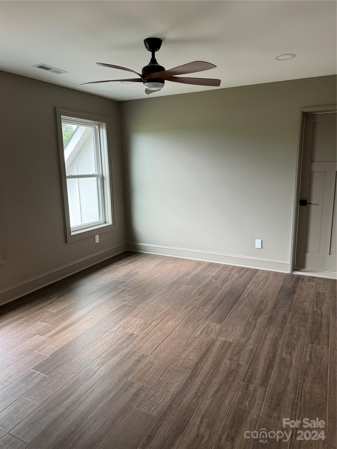 4305 Holly Circle Northeast Conover, NC 28613 - Photo 13 of 36 wooden floor in an empty room with a window