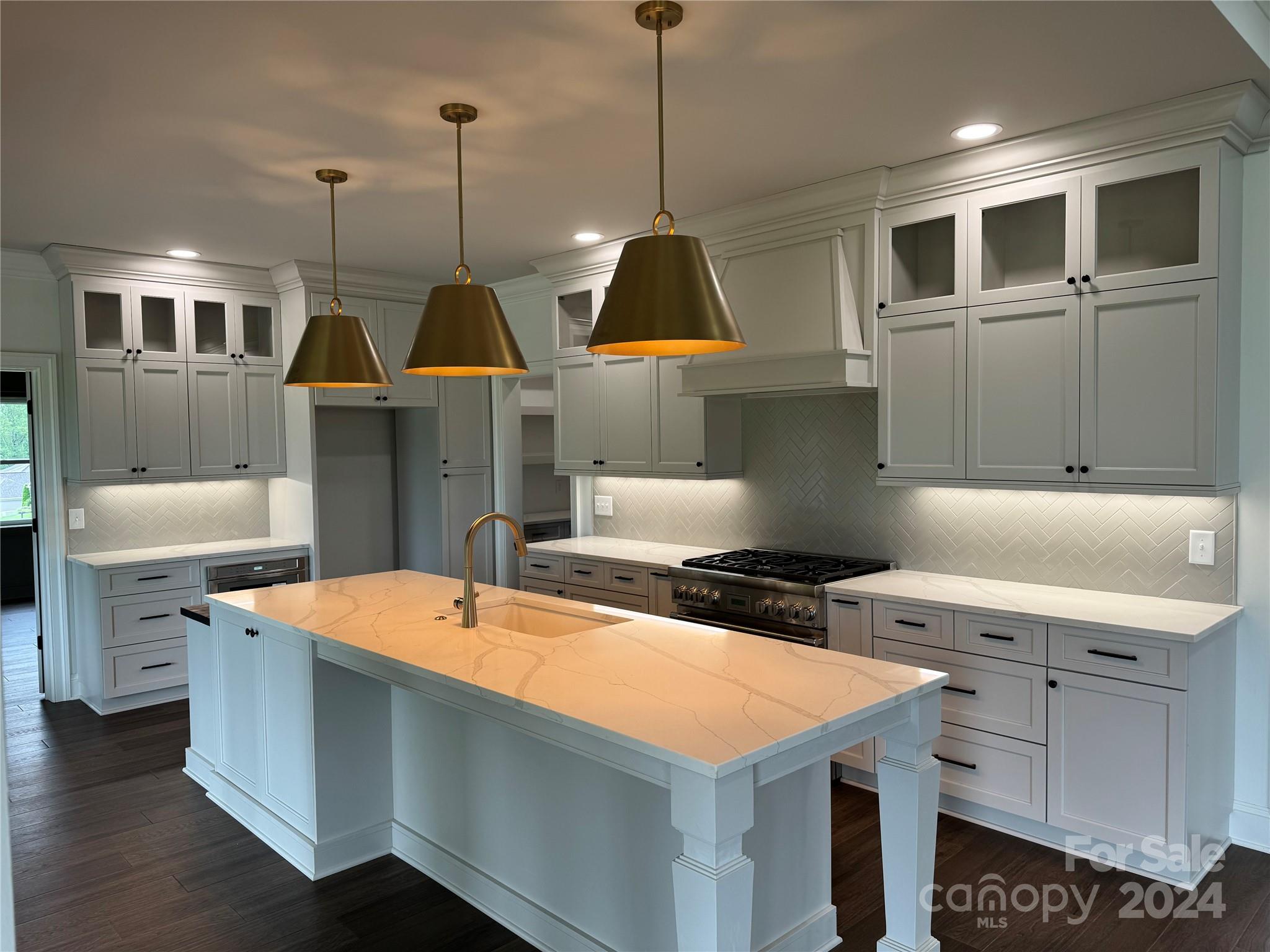 4305 Holly Circle Northeast Conover, NC 28613 - Photo 16 of 36 a kitchen that has a sink a stove and a wooden floor