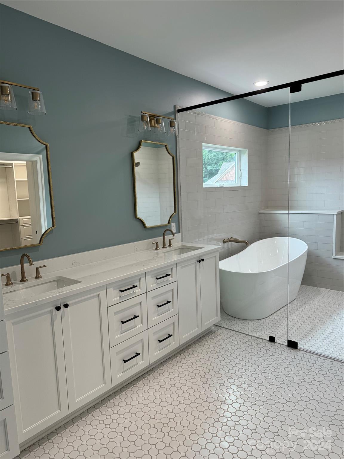 4305 Holly Circle Northeast Conover, NC 28613 - Photo 19 of 36 a bathroom with a double vanity sink a mirror and a bathtub