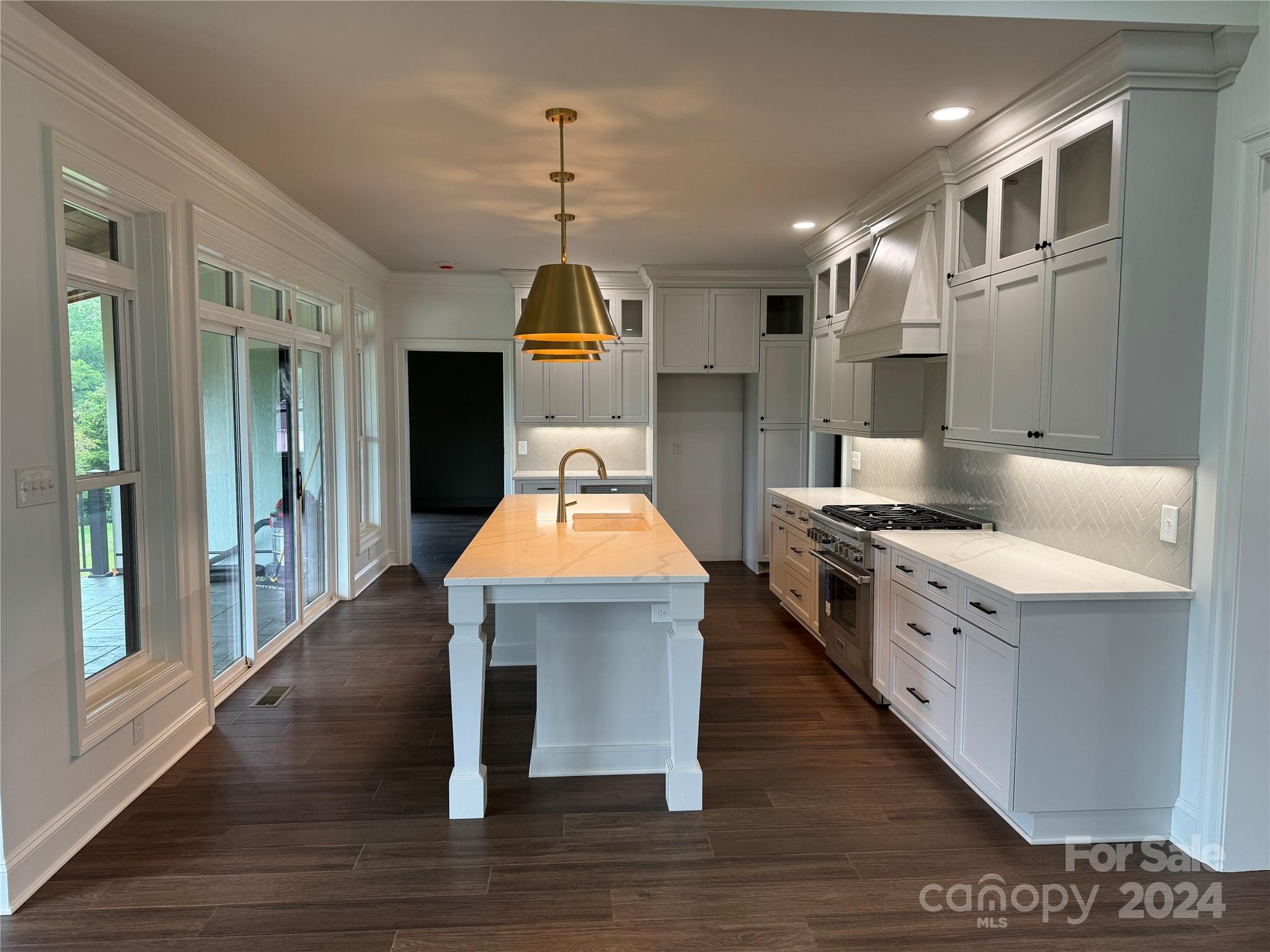 4305 Holly Circle Northeast Conover, NC 28613 - Photo 2 of 36 a kitchen with kitchen island stainless steel appliances a sink cabinets and wooden floor