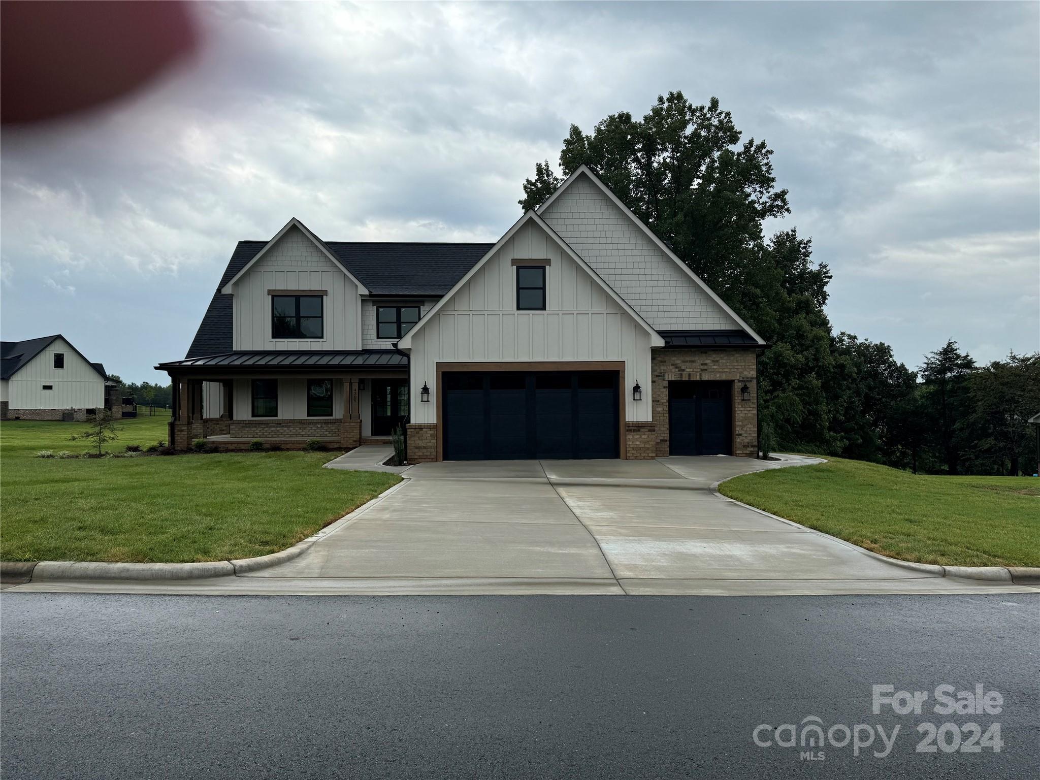 4305 Holly Circle Northeast Conover, NC 28613 - Photo 23 of 36 a front view of a house with a garden and trees