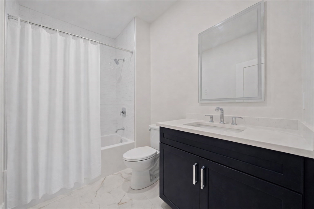 77 Neponset Street, Unit 77 Canton, MA 02021 - Photo 11 of 28 a bathroom with a toilet a sink and a mirror