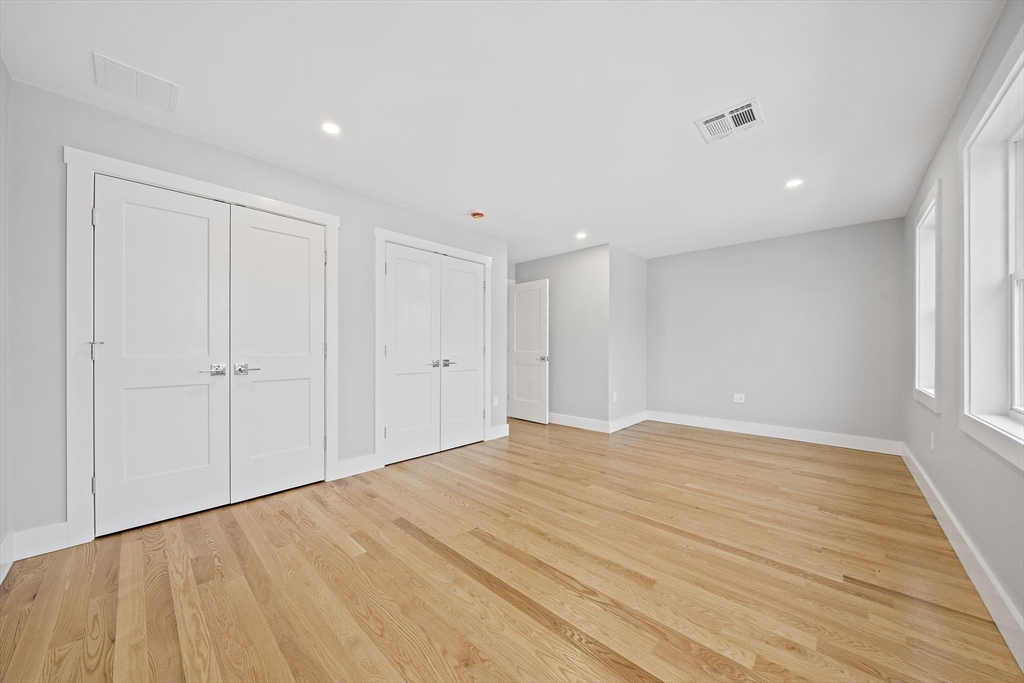 77 Neponset Street, Unit 77 Canton, MA 02021 - Photo 17 of 25 a view of empty room with wooden floor and fan