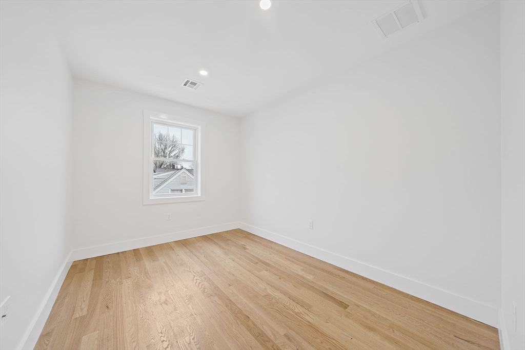 77 Neponset Street, Unit 77 Canton, MA 02021 - Photo 19 of 25 a view of empty room with wooden floor