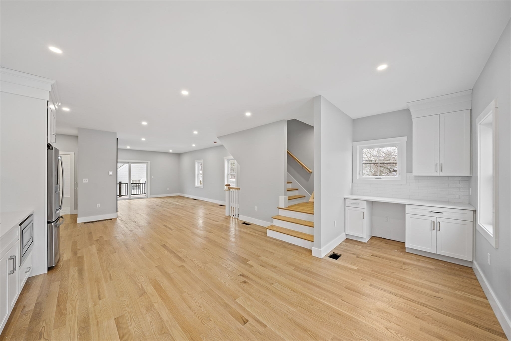 77 Neponset Street, Unit 77 Canton, MA 02021 - Photo 7 of 28 a view of empty room with wooden floor and window