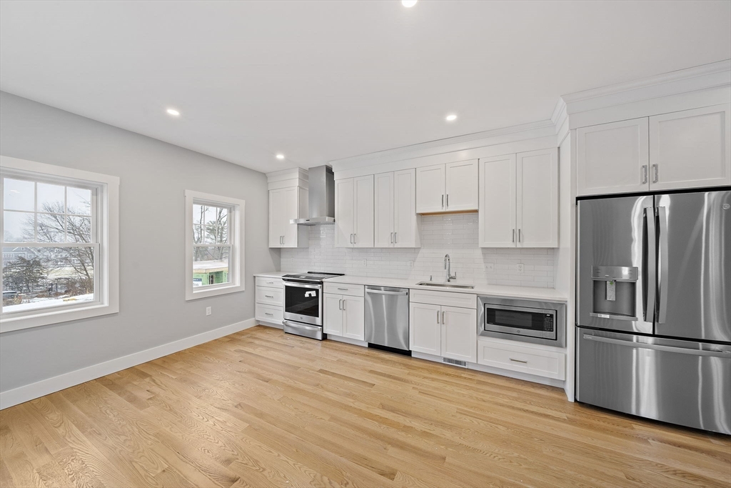77 Neponset Street, Unit 77 Canton, MA 02021 - Photo 8 of 25 a kitchen with granite countertop a refrigerator stove top oven and sink