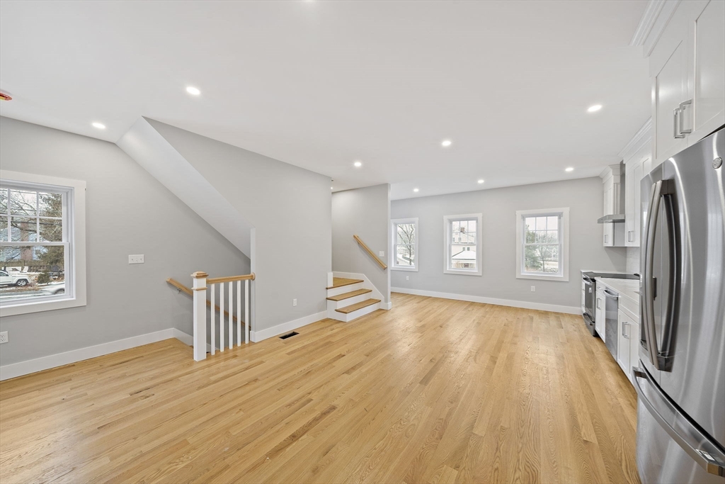 77 Neponset Street, Unit 77 Canton, MA 02021 - Photo 8 of 28 a view of empty room with wooden floor and fan