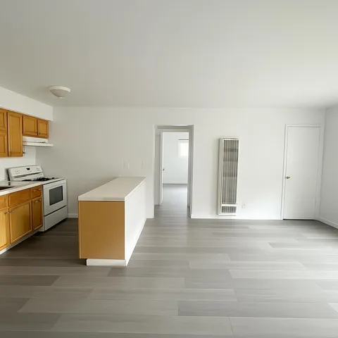 a view of kitchen with stainless steel appliances granite countertop a stove a sink and a refrigerator