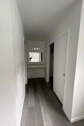 a view of a room that has a hardwood floor