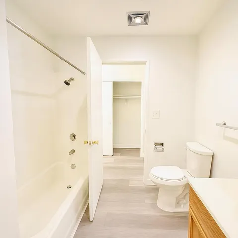 a bathroom with a toilet a sink and bathtub