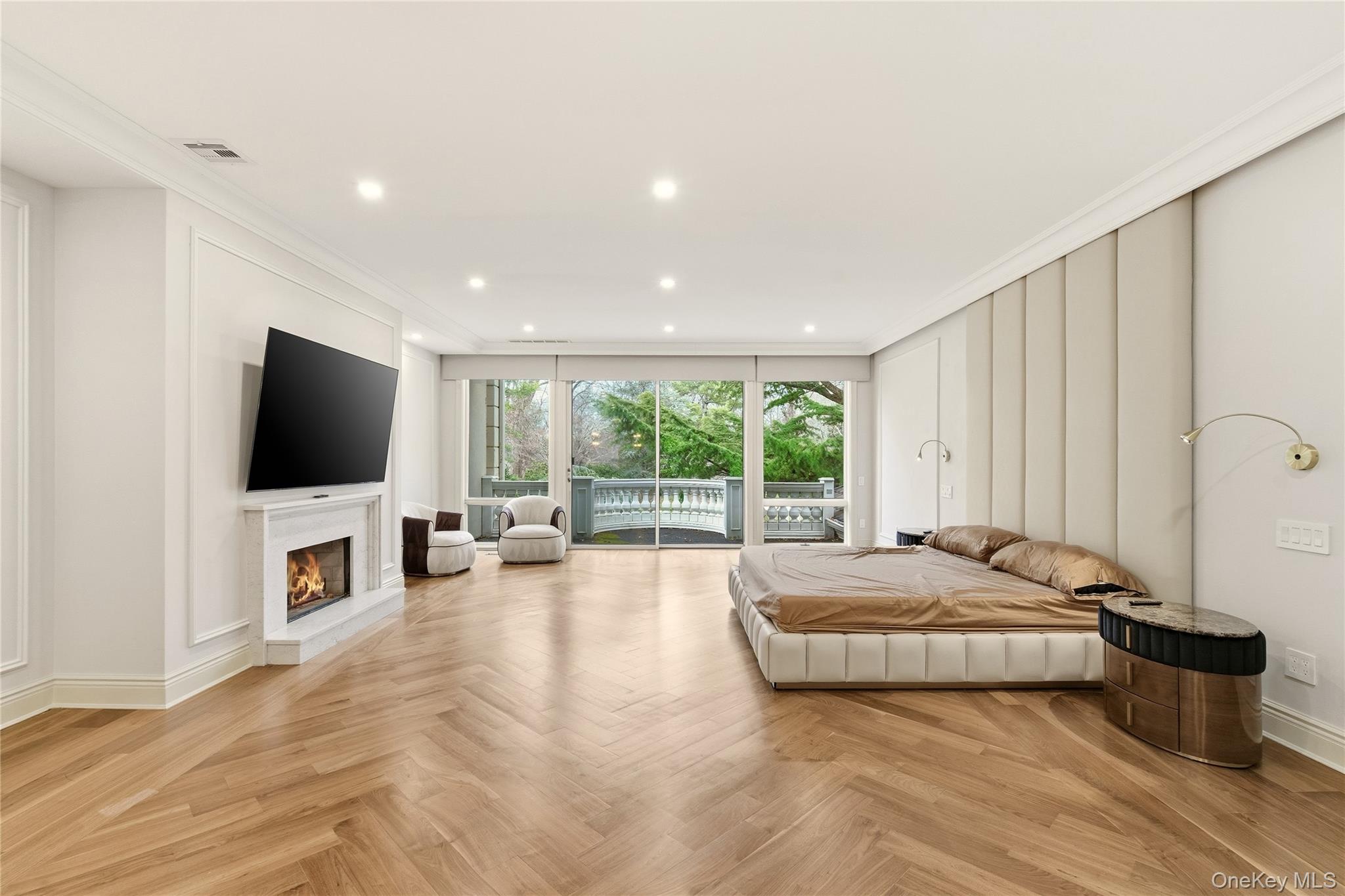 55 Coves Run Syosset, NY 11791 - Photo 25 of 50 a spacious bedroom with a large bed and a flat screen tv