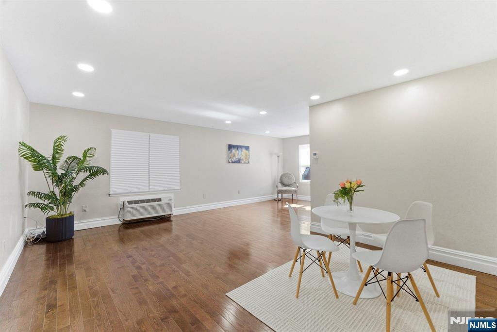 144 70th Street, Unit 1E Guttenberg, NJ 07093 - Photo 1 of 20 a view of a work space with furniture and wooden floor