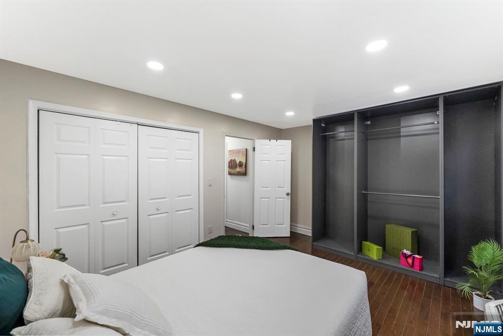 144 70th Street, Unit 1E Guttenberg, NJ 07093 - Photo 12 of 20 a bedroom with a bed and a dresser