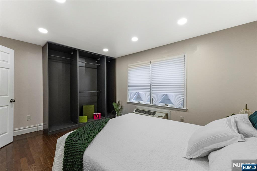 144 70th Street, Unit 1E Guttenberg, NJ 07093 - Photo 13 of 20 a bedroom with a bed and a window