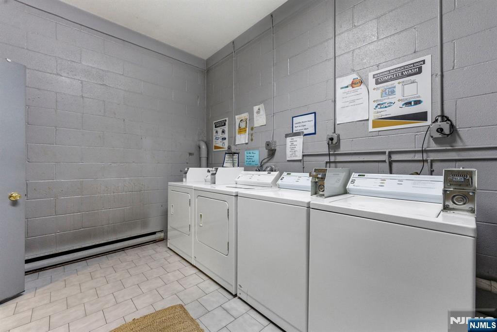 144 70th Street, Unit 1E Guttenberg, NJ 07093 - Photo 15 of 20 a room with sink dryer and washer