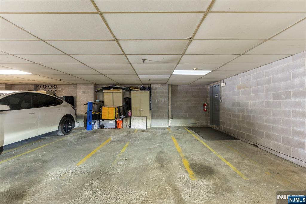 144 70th Street, Unit 1E Guttenberg, NJ 07093 - Photo 16 of 20 a view of a garage with parked cars