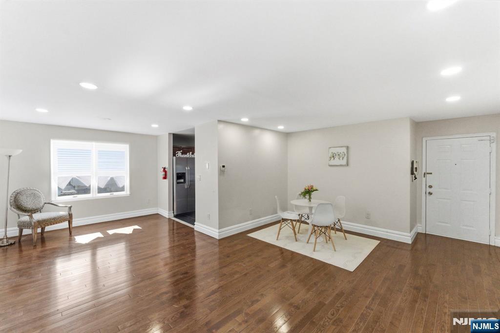 144 70th Street, Unit 1E Guttenberg, NJ 07093 - Photo 2 of 20 a view of a livingroom with furniture wooden floor and windows