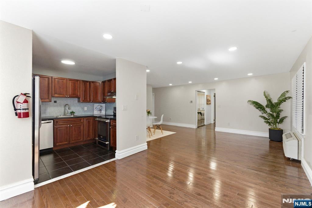 144 70th Street, Unit 1E Guttenberg, NJ 07093 - Photo 4 of 20 a view of an entryway with wooden floor