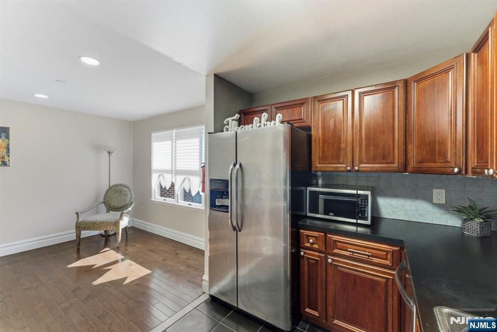 144 70th Street, Unit 1E Guttenberg, NJ 07093 - Photo 6 of 20 a kitchen with stainless steel appliances granite countertop a refrigerator and a stove top oven