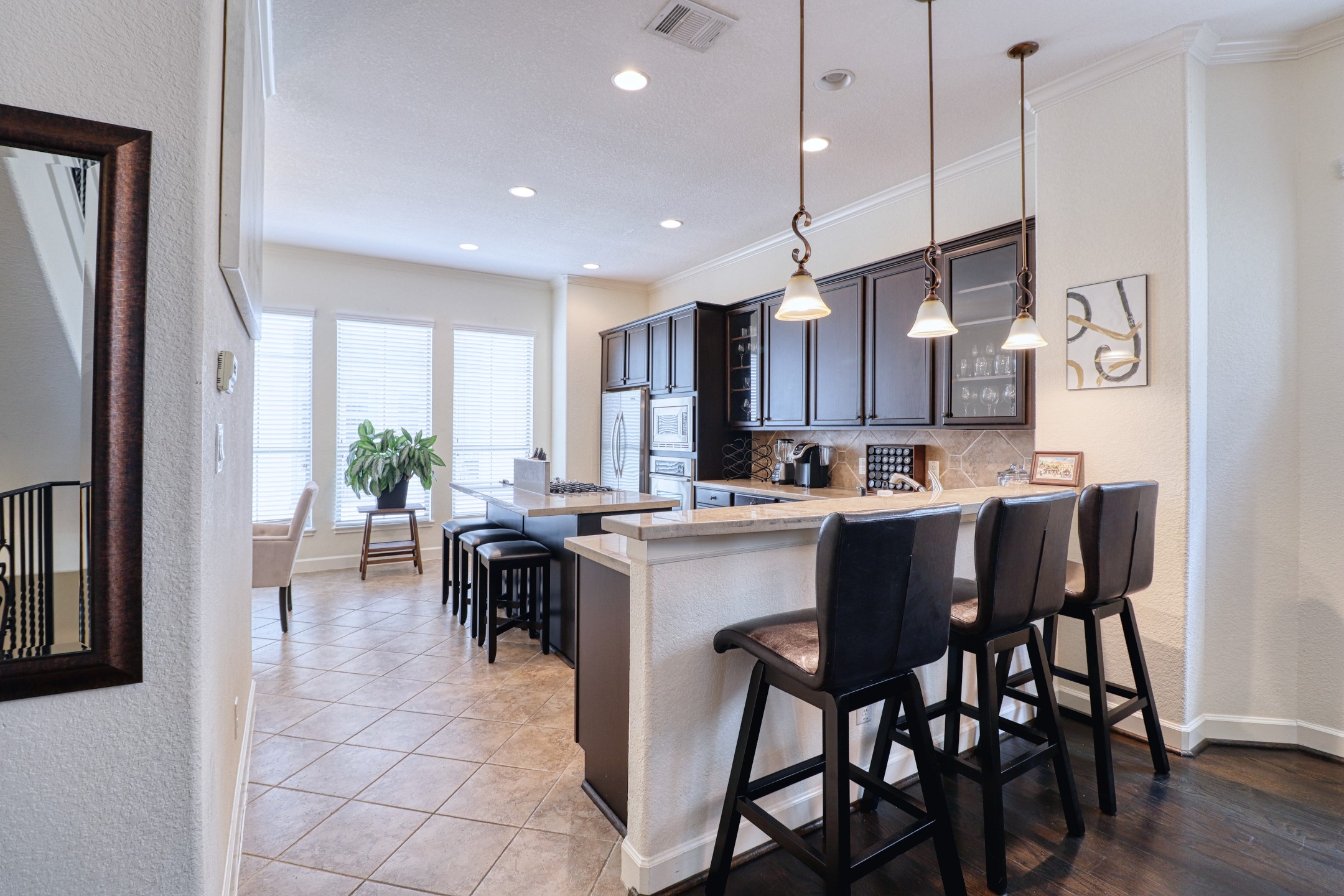904 Patterson Street Houston, TX 77007 - Photo 14 of 30 a kitchen with a dining table chairs sink and cabinets