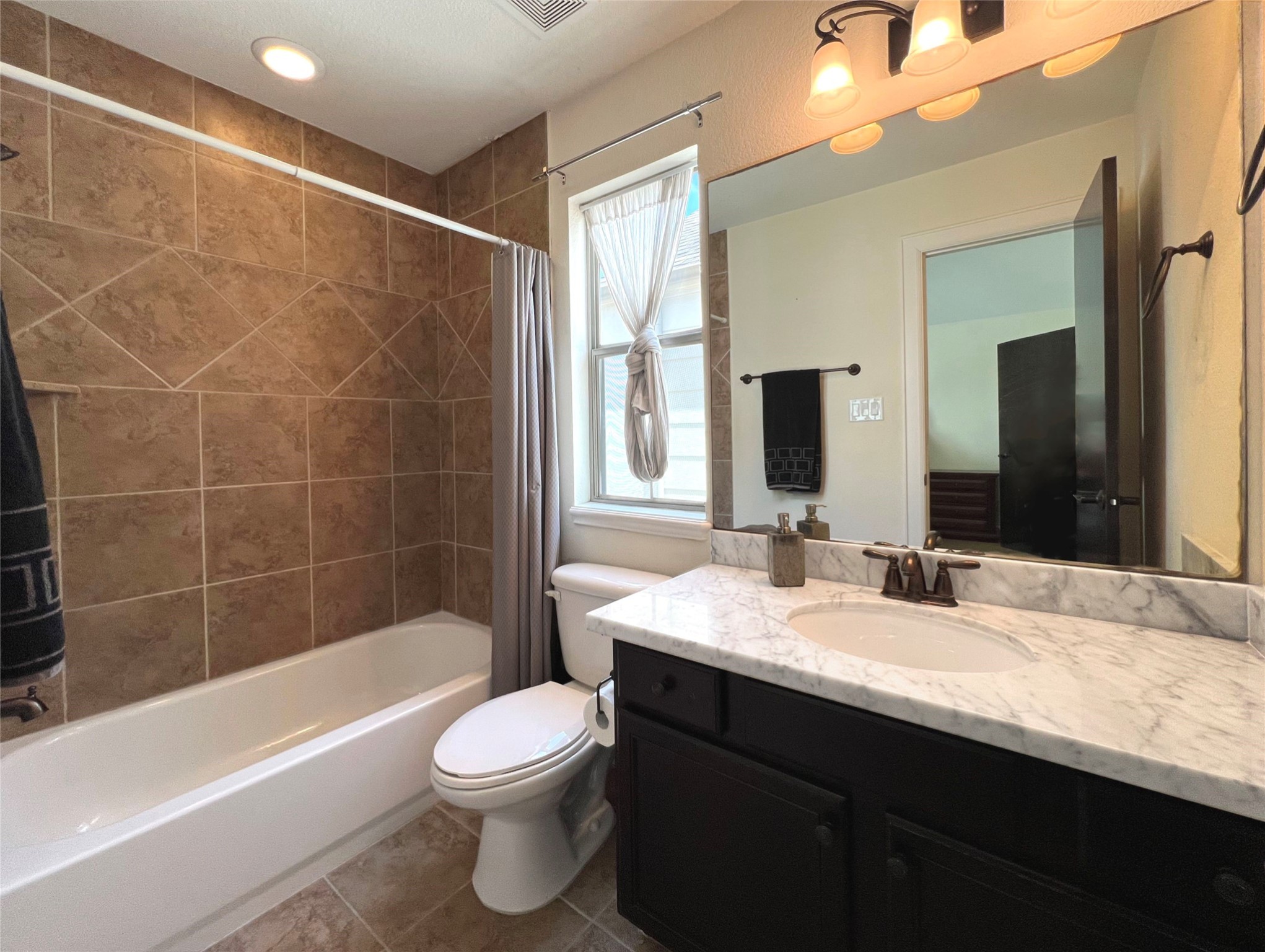 904 Patterson Street Houston, TX 77007 - Photo 30 of 30 a bathroom with a bathtub shower sink vanity mirror and toilet