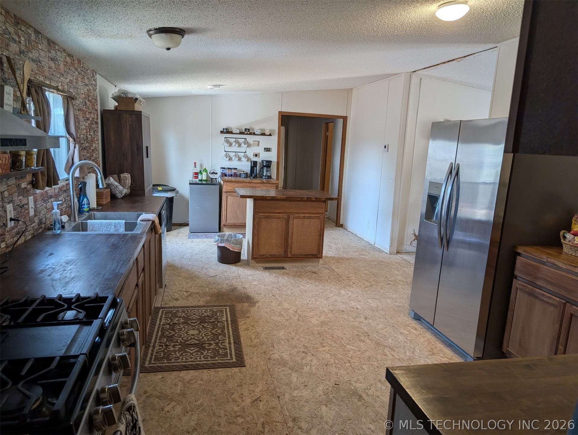 57334 South 36730th Road Terlton, OK 74081 - Photo 7 of 23 Kitchen featuring wood-finish countertops, stainless steel appliances, and a gas range