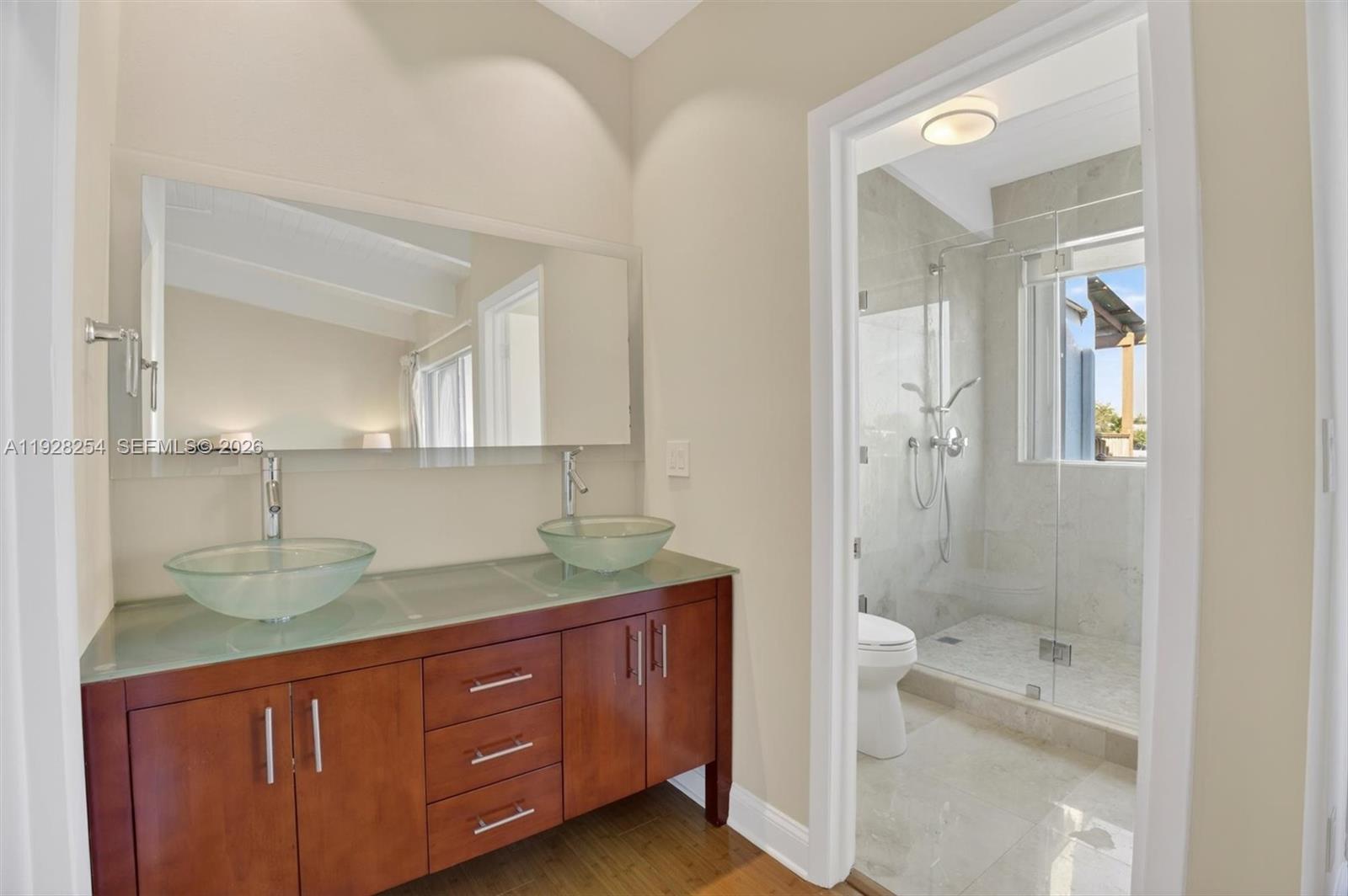 7043 Southwest 53rd Lane Miami, FL 33155 - Photo 21 of 41 a bathroom with a granite countertop sink mirror and double