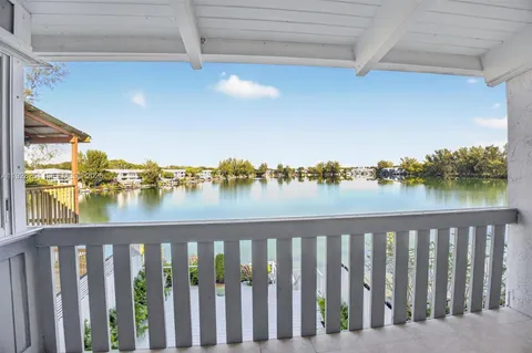 a view of a lake with a table and chairs