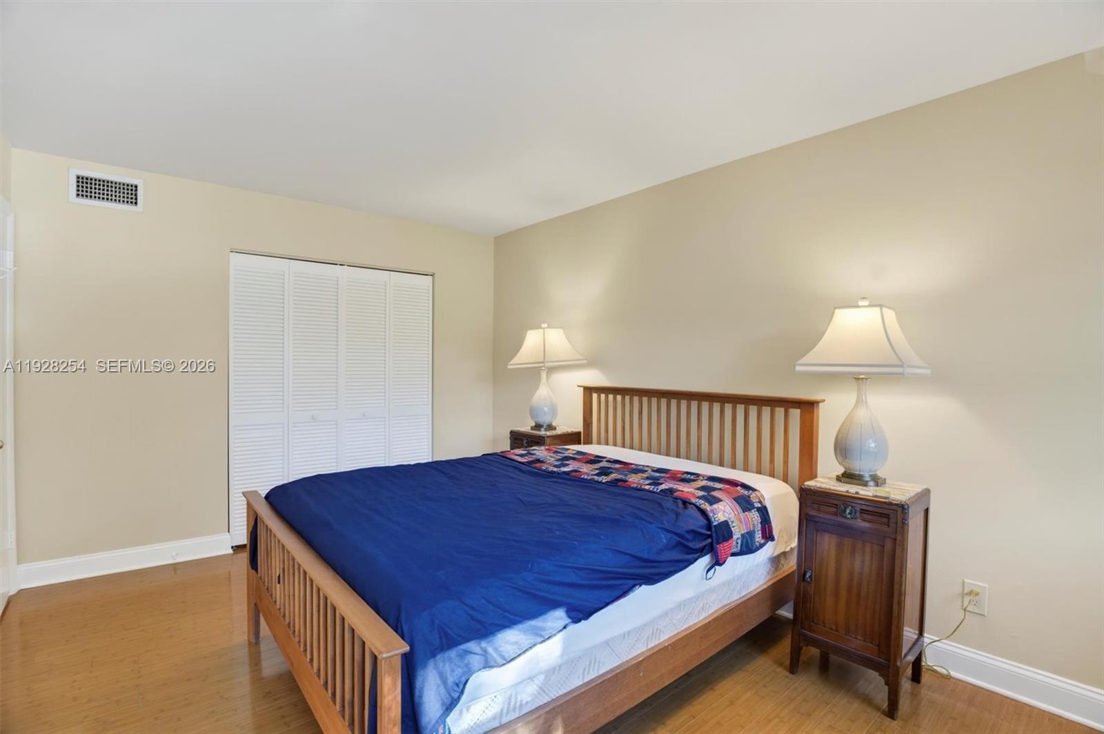 7043 Southwest 53rd Lane Miami, FL 33155 - Photo 28 of 41 a bedroom with a bed and a lamp