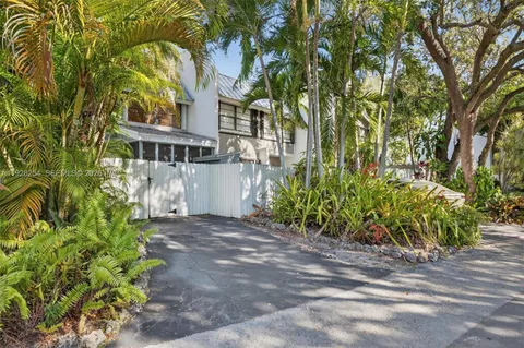 an aerial view of a house with swimming pool garden and patio