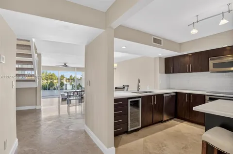 a kitchen with a table chairs stove and cabinets