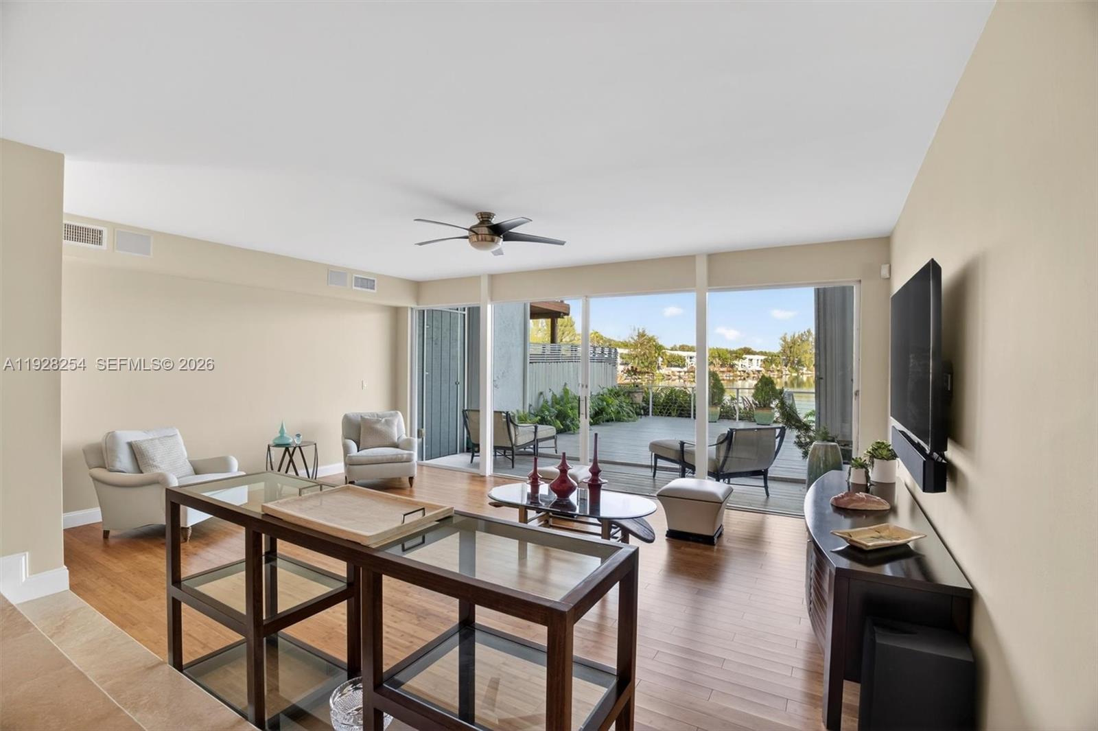 7043 Southwest 53rd Lane Miami, FL 33155 - Photo 9 of 41 a living room with furniture a flat screen tv and a large window