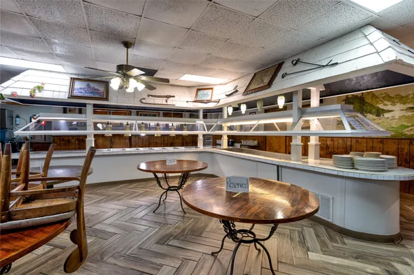 a view of a chairs and tables in wooden floor