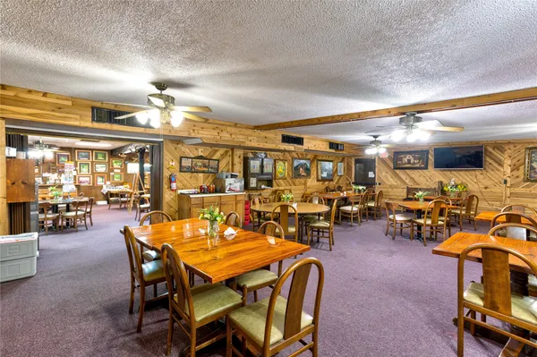 a view of a dining room with furniture and chandelier