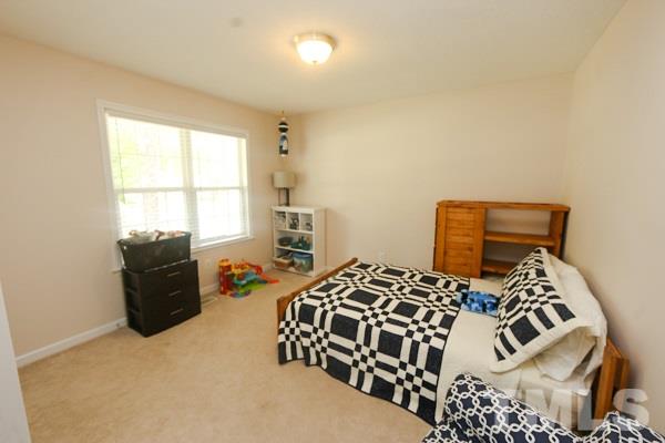 122 Forest Lane Garner, NC 27529 - Photo 11 of 18 a bedroom with a bed and a window